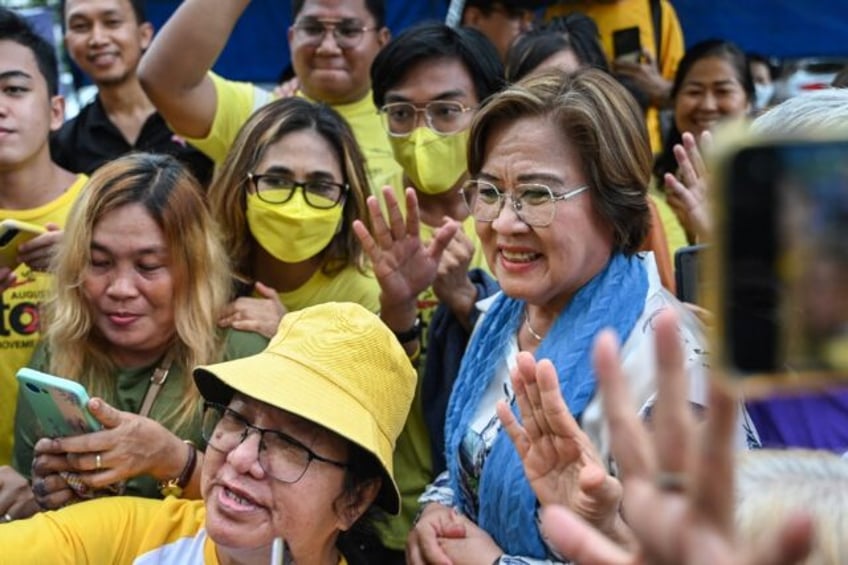 Former Philippine senator and human rights campaigner Leila de Lima (R) acknowledges suppo