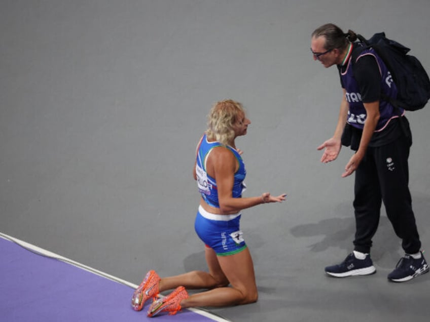 Valentina Petrillo of Italy, first transgender athlete knees on the ground after competing