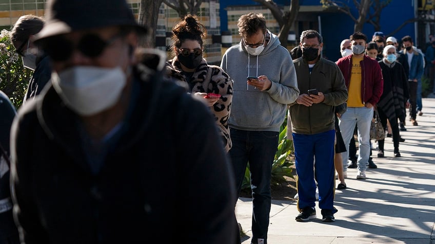 People wait in line for a COVID-19 test in Los Angeles, Jan. 4, 2022.