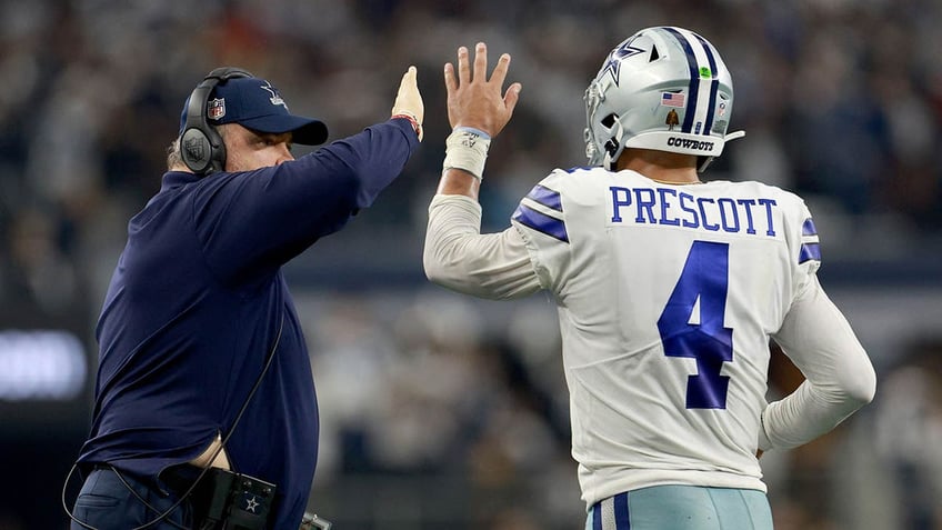 Mike McCarthy celebrates with Dak Prescott