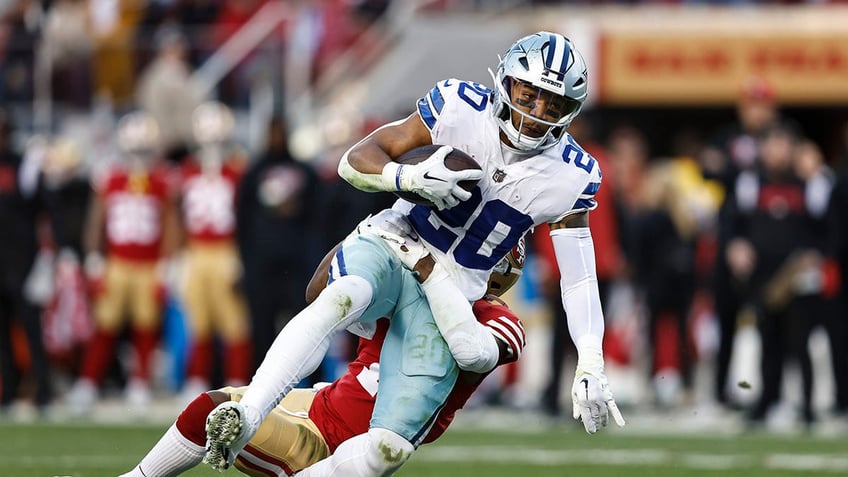 Tony Pollard is tackled during an NFL game