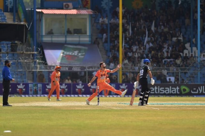 Afghan Cricket players from the Speen Ghar Tigers team (Orange) play against the Mis-e-Ain