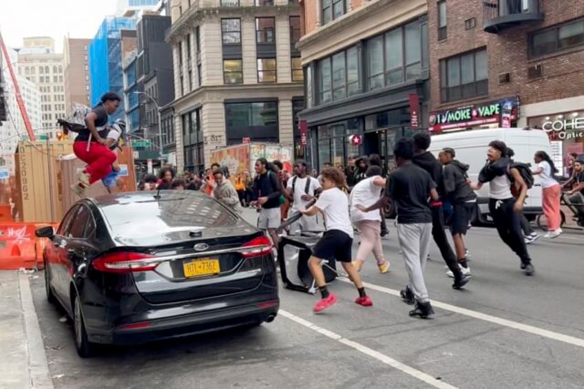 crowd overwhelms new york citys union square tosses chairs climbs on vehicles