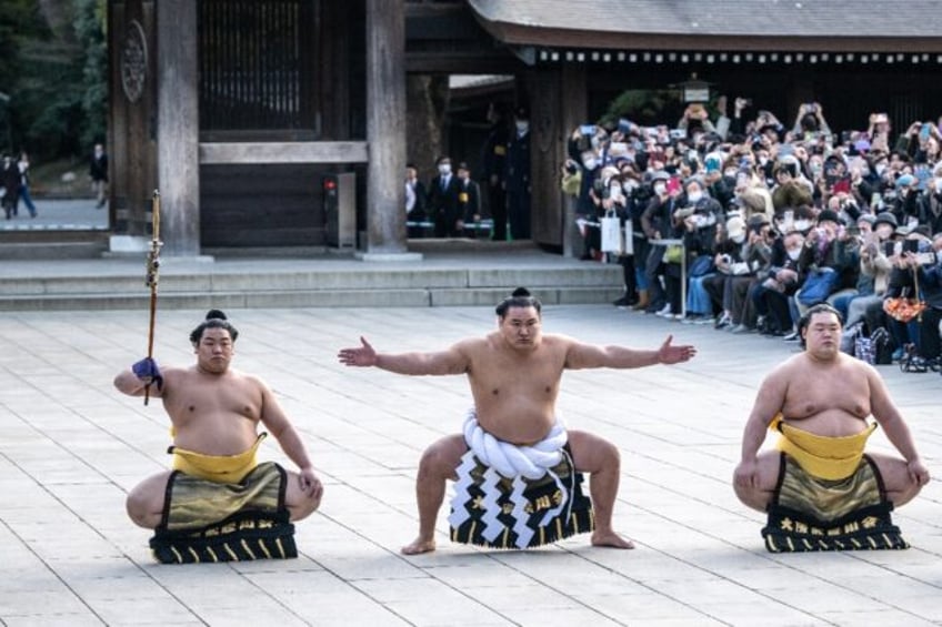 Mongolian-born Hoshoryu (C) became the 74th yokozuna, or grand champion