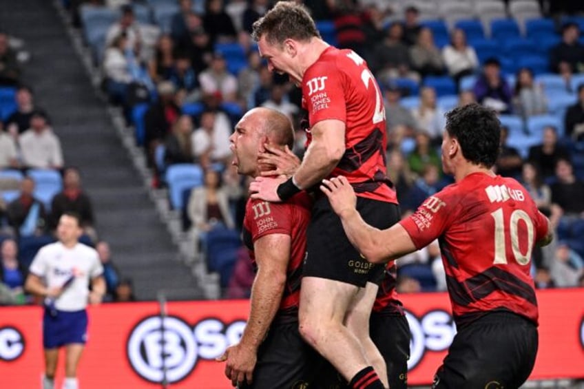 Crusaders' Tom Christie (left) celebrates his try with teammates against New South Wales W