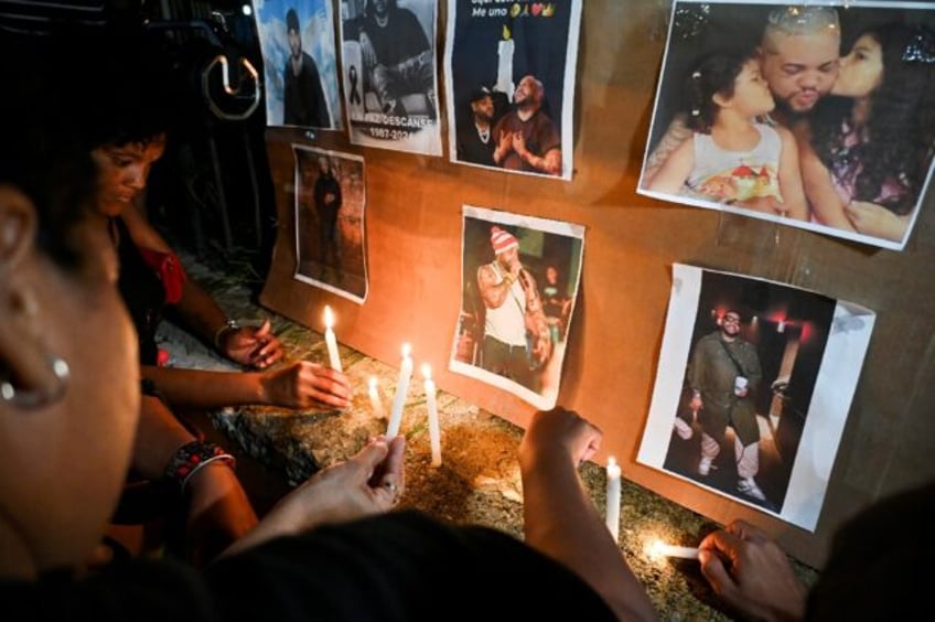 Cuban fans light candles next to pictures of the late singer, Jose Manuel Carbajal Zaldiva