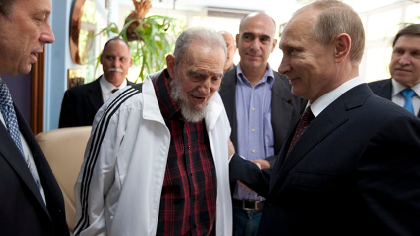 Cubas Fidel Castro, center, meets with Russias President Vladimir Putin, right, in Havana, Cuba, Friday, July 11, 2014. Putin began a Latin American tour aimed at boosting trade and ties in the region with a stop Friday in Cuba, a key Soviet ally during the Cold War that has backed Moscow in its dispute with the West over Ukraine. (AP Photo/Alex Castro)