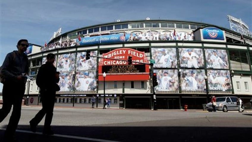 April 4, 2012: People walk by the Marquee at Wrigley Field, one day before the Chicago Cubs' home opener against the Washington Nationals in Chicago. 