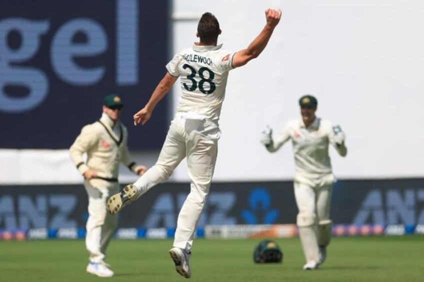 Josh Hazlewood celebrates taking the final wicket as Australia beat New Zealand in the fir