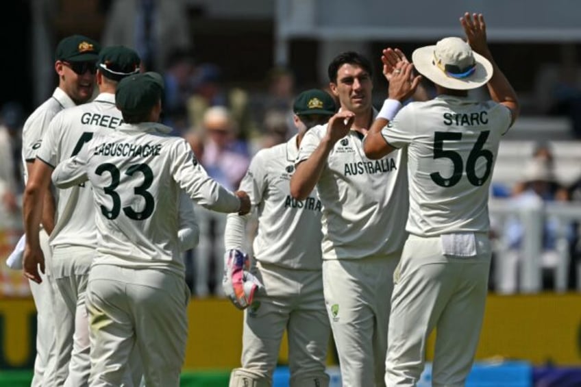 Australia captain Pat Cummins (2R) celebrates with team-mates after dismissing South Afric