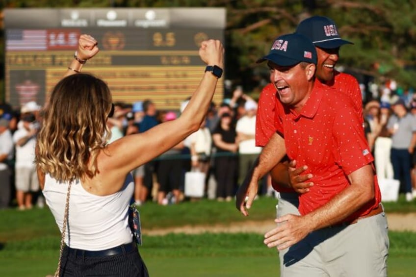 Keegan Bradley, right, celebrates with wife Jillian, left, after taking a trophy-clinching