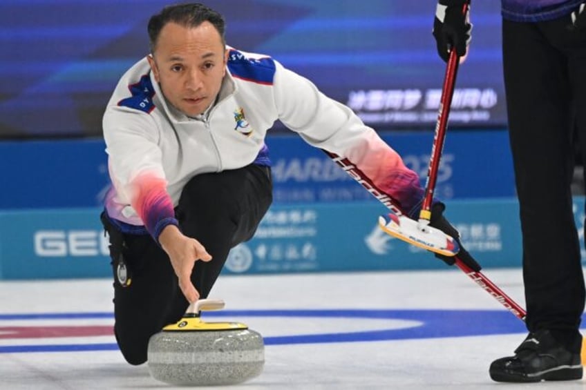 Philippines curler Alan Frei delivers a stone during curling round robin match against Kaz