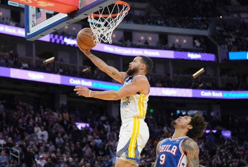 Golden State star Stephen Curry makes a layup in Tuesday's win over Philadelphia