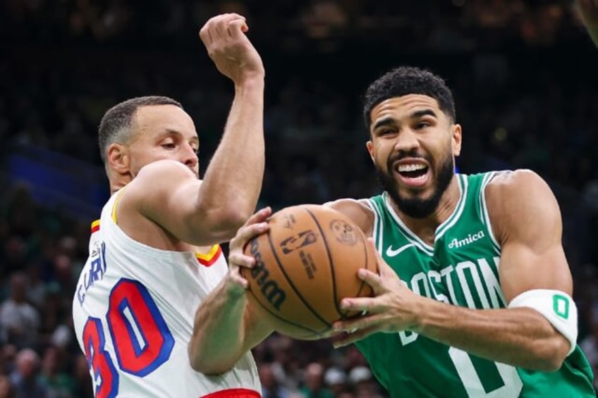 Boston's Jayson Tatum (right) battles with Golden State's Stephen Curry in a see-saw NBA c