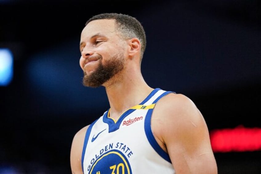 Golden State guard Stephen Curry grimaces on the court after suffering a left ankle injury