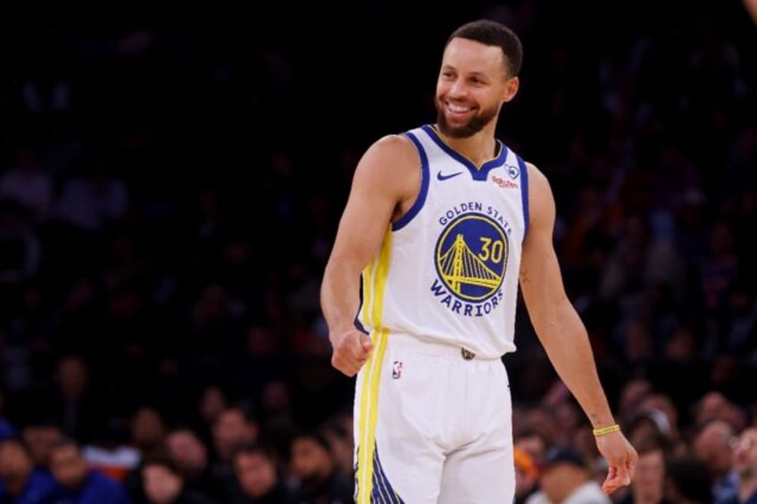 Golden State Warriors star Stephen Curry reacts during his team's NBA victory over the New