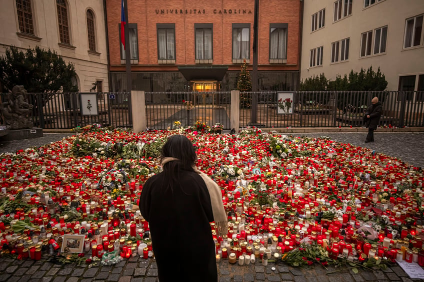 PRAGUE, CZECH REPUBLIC - DECEMBER 23: A woman mourns outside the building of Charles University following a mass shooting earlier this week, on December 23, 2023 in Prague, Czech Republic. Considered the country's worst mass shooting, fourteen people were killed and 25 injured on December 21st in the Czech capital, with police confirming the 24-year-old student gunman dead at the Prague university building. (Photo by Gabriel Kuchta/Getty Images)