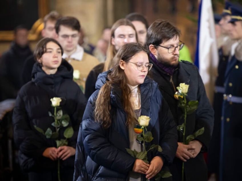 PRAGUE, CZECH REPUBLIC - DECEMBER 23: Students bring flowers for each late victim during a memorial service following a mass shooting earlier this week, on December 23, 2023 in Prague, Czech Republic. Considered the country's worst mass shooting, fourteen people were killed and 25 injured on December 21st in the …