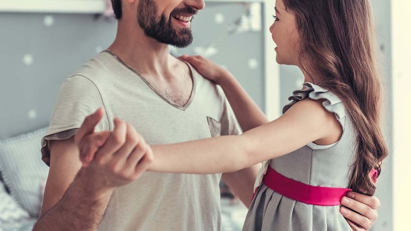 Dad smiling with daughter