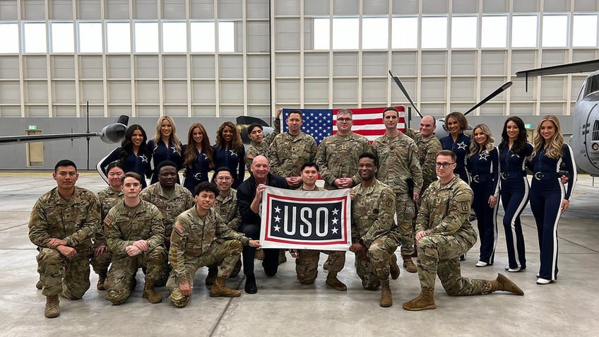 The Dallas Cowboys Cheerleaders posing with American troops