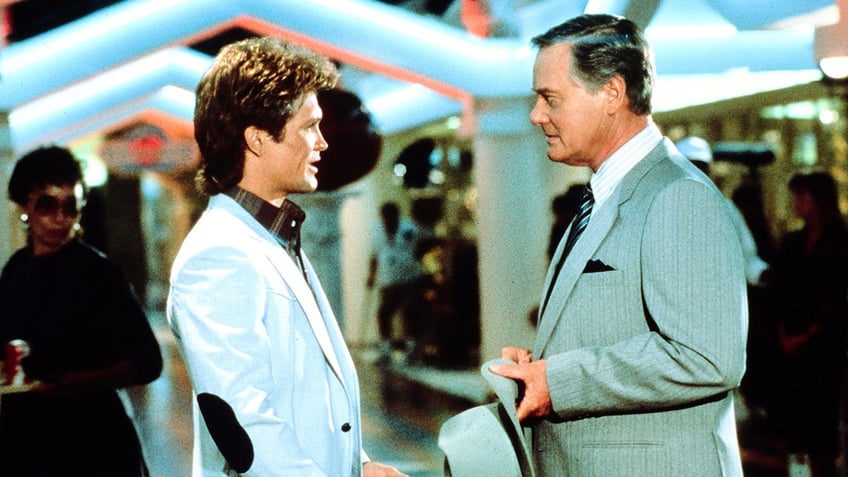 Dack Rambo speaking to Larry Hagman in a scene from Dallas