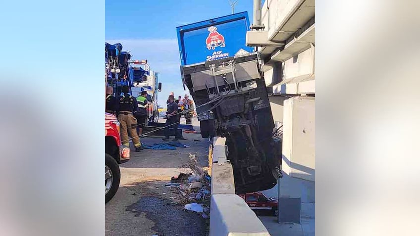 dallas truck driver rescued from vehicle hanging off bridge