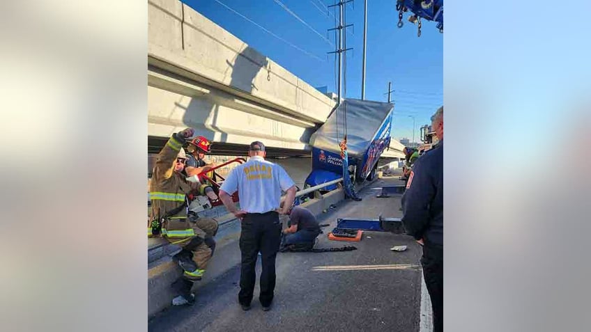 dallas truck driver rescued from vehicle hanging off bridge