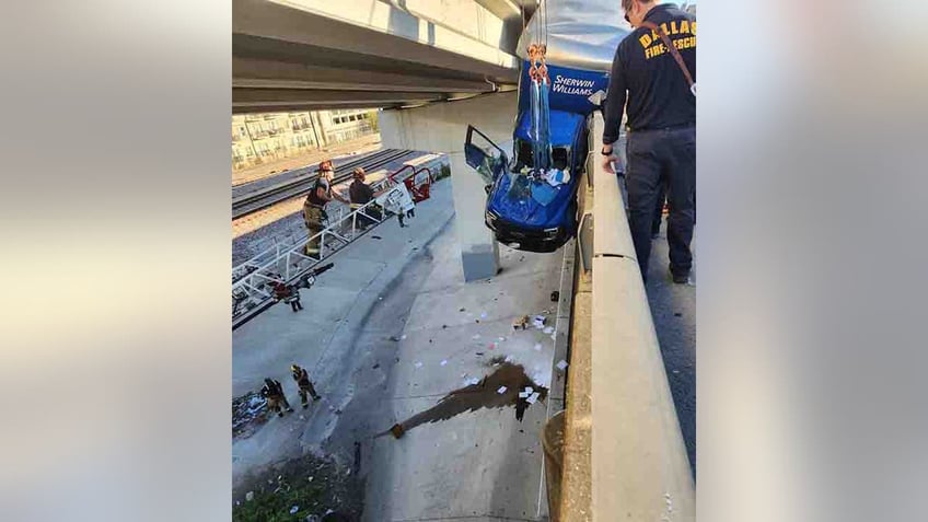 dallas truck driver rescued from vehicle hanging off bridge