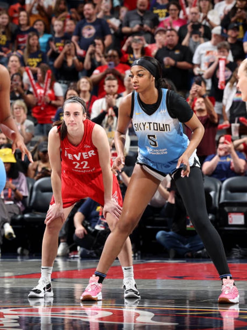 Caitlin Clark of the Indiana Fever and Angel Reese of the Chicago Sky look on during the game on June 1, 2024 at Gainbridge Fieldhouse in...