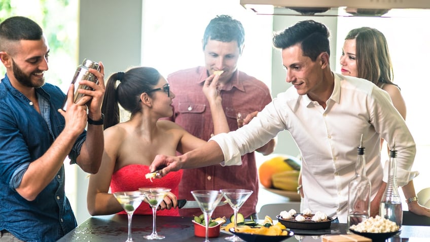 Group of friends toasting with different cocktails.