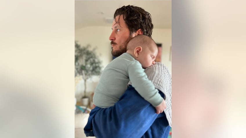 Val Chmerkovskiy holding his baby son