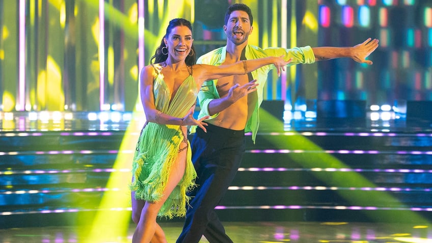 Jenna Johnson and Joey Graziadei in neon green outfits dance in the finale of "Dancing with the Stars"