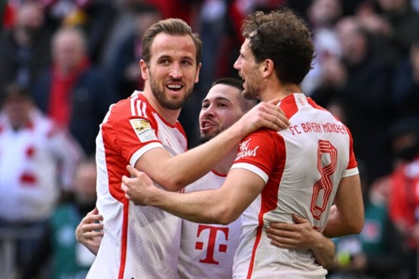 Bayern Munich midfielder Leon Goretzka (R) with Harry Kane (L). Kane has 30 league goals t