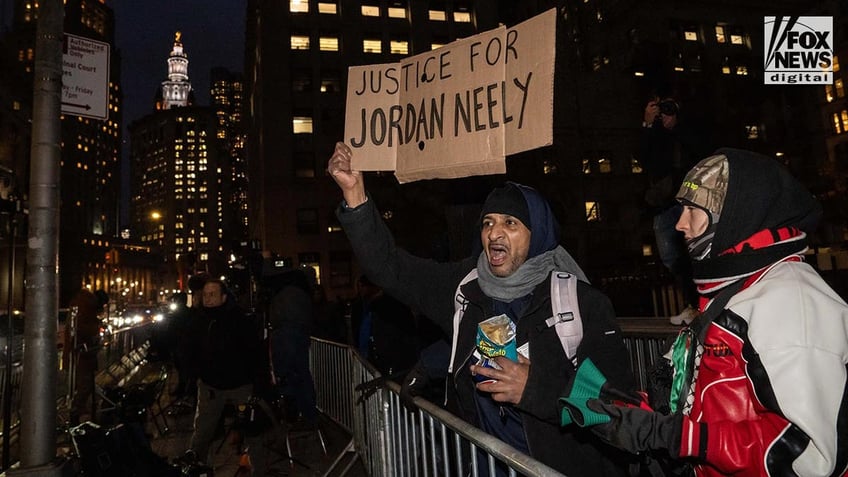 Protestors shout as Daniel Penny departs Manhattan Criminal Court following the second day of jury deliberations