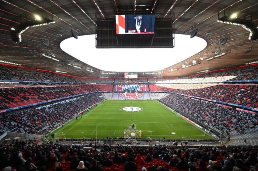 Wreaths of flowers lay next to a picture of late German football legend Franz Beckenbauer at Bayern Munich's Allianz Arena on Friday