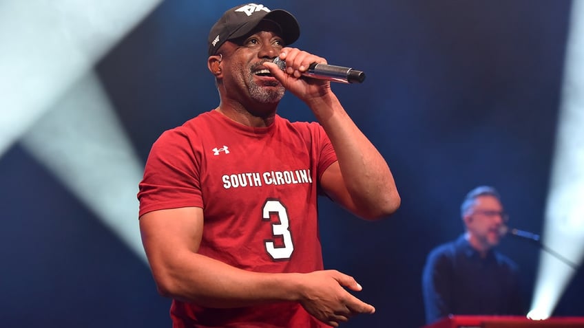 Darius Rucker on stage in a red shirt in London