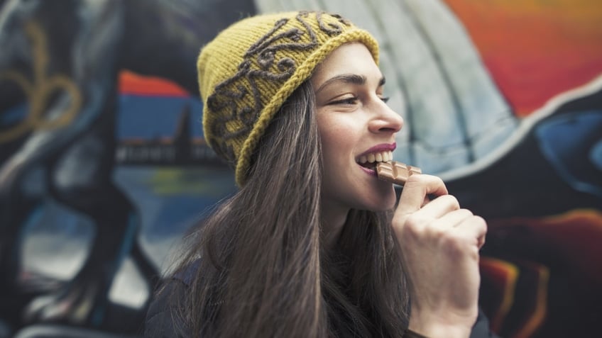 Woman eating chocolate.