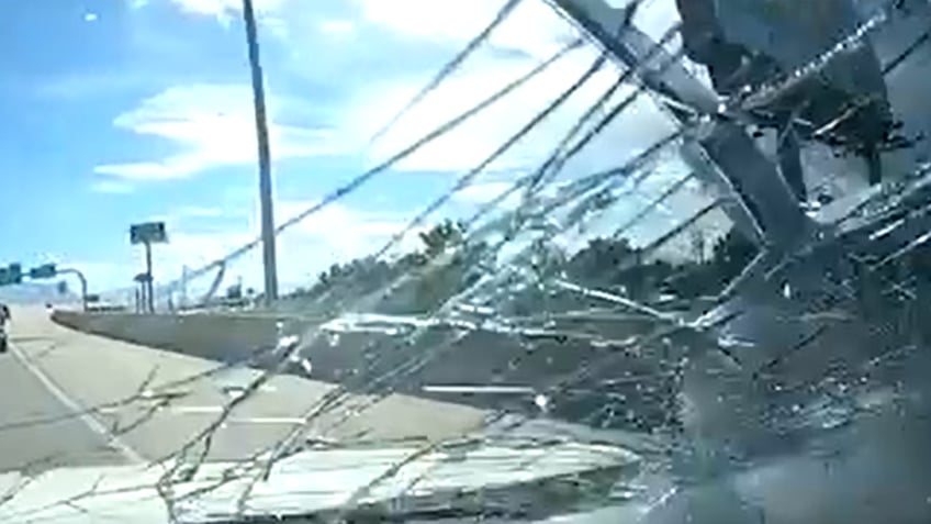 dash camera captures office chair smashing into cars windshield on interstate