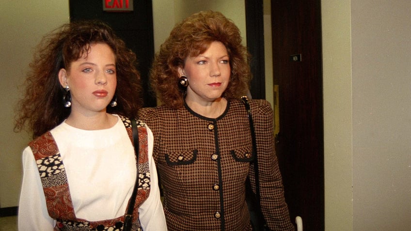 High school cheerleader Amber Heath, left, and her mother Verna Heath enter a courtroom