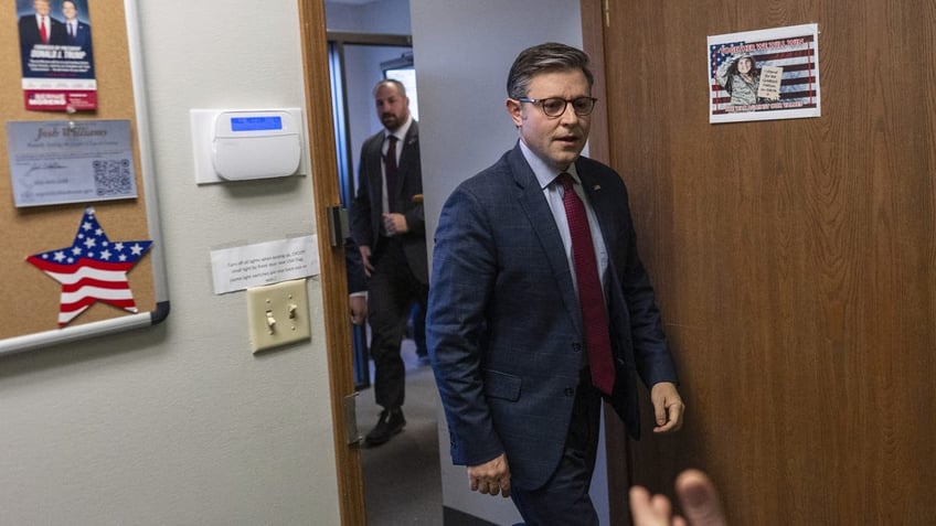 Speaker of the House Mike Johnson, R-La., is greeted as he arrives to speak at a campaign event at the Lucas County Republican Party headquarters in Holland, Ohio, Saturday, Oct. 26, 2024.