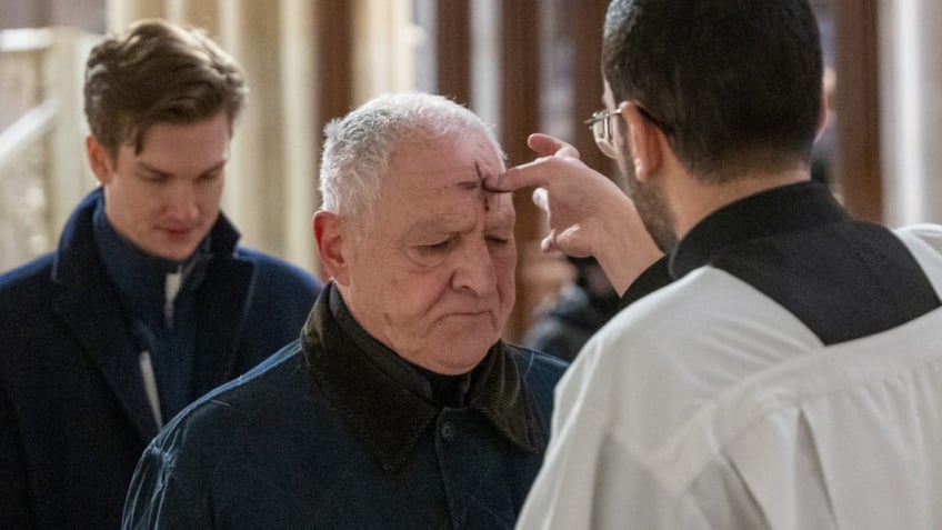 NEW YORK, NEW YORK - FEBRUARY 14: People get the sign of the cross placed on their forehead by a priest at St. Patricks Cathedral on Ash Wednesday on February 14, 2024 in New York City. Ash Wednesday marks the start of Lent for Catholics, a 40-day season of prayer, fasting and giving in preparation for the day of Christ's resurrection, celebrated on Easter Sunday. (Photo by Spencer Platt/Getty Images)