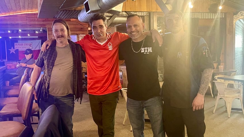 Columnist David Marcus, in the red shirt, with Cleveland, Texas, residents Jason, George Cuellar, and Tyler.