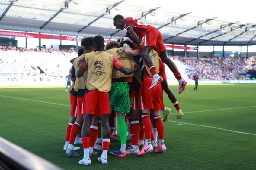 Canada goalscorer Jonathan David is mobbed by team-mates after scoring the only goal in a