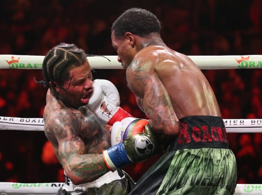 Lamont Roach punches Gervonta Davis during their bout for Davis' WBA lightweight world tit