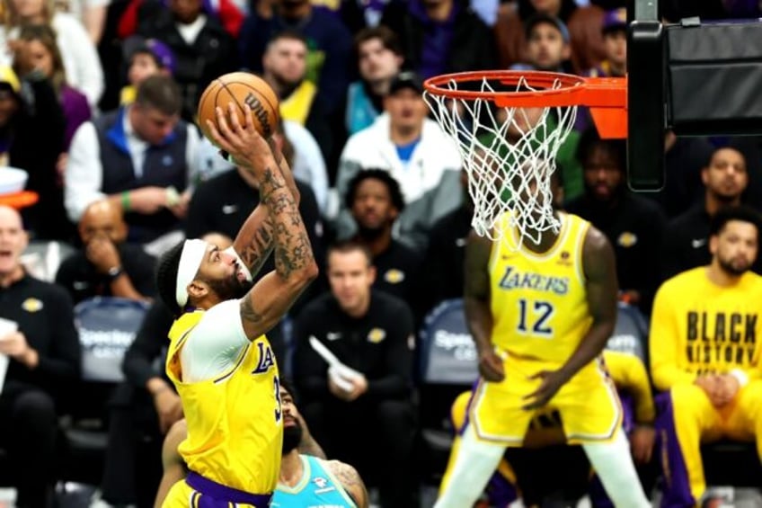 Anthony Davis of the Los Angeles Lakers dunks the ball on his way to a triple double against Charlotte in a 124-118 victory over the host Hornets