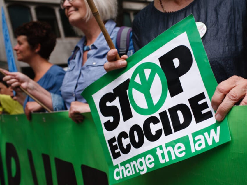 Members and supporters of climate change activist group Extinction Rebellion hold a banner across the Strand at Aldwych on the opening day of the group's 'Summer Uprising' demonstration outside the Royal Courts of Justice in London, England, on July 15, 2019. Demonstrations were also held in Bristol, Cardiff, Leeds and …