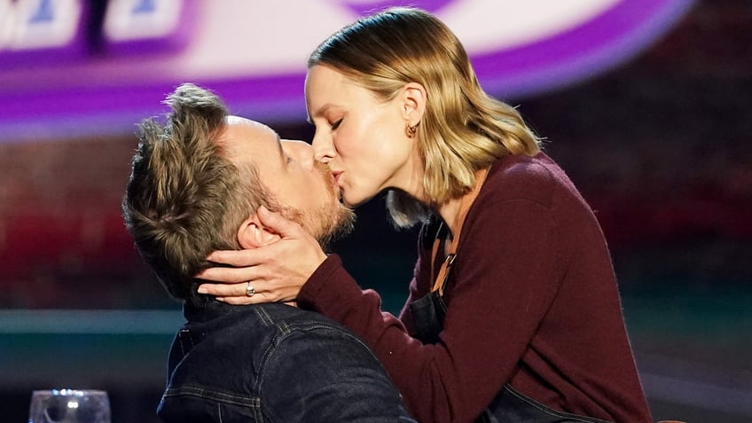 Dax Shepard and his wife Kristen Bell share a kiss on the set of "Family Game Night."