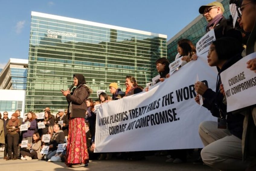 Environmental activists demonstrate in front of the convention centre in Busan where negot