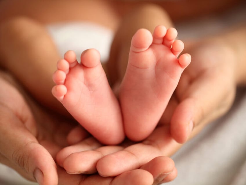 Close up of newborn baby legs