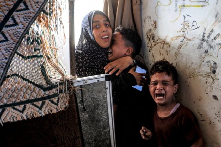 A Gaza family after Israeli bombardment in Nuseirat in the central Gaza Strip on July 6, 2